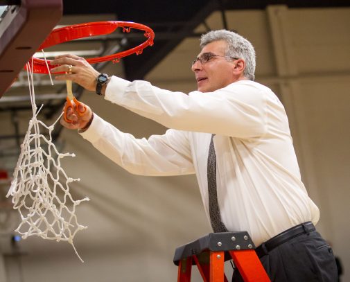 Azain cuts the net following a championship in 2013